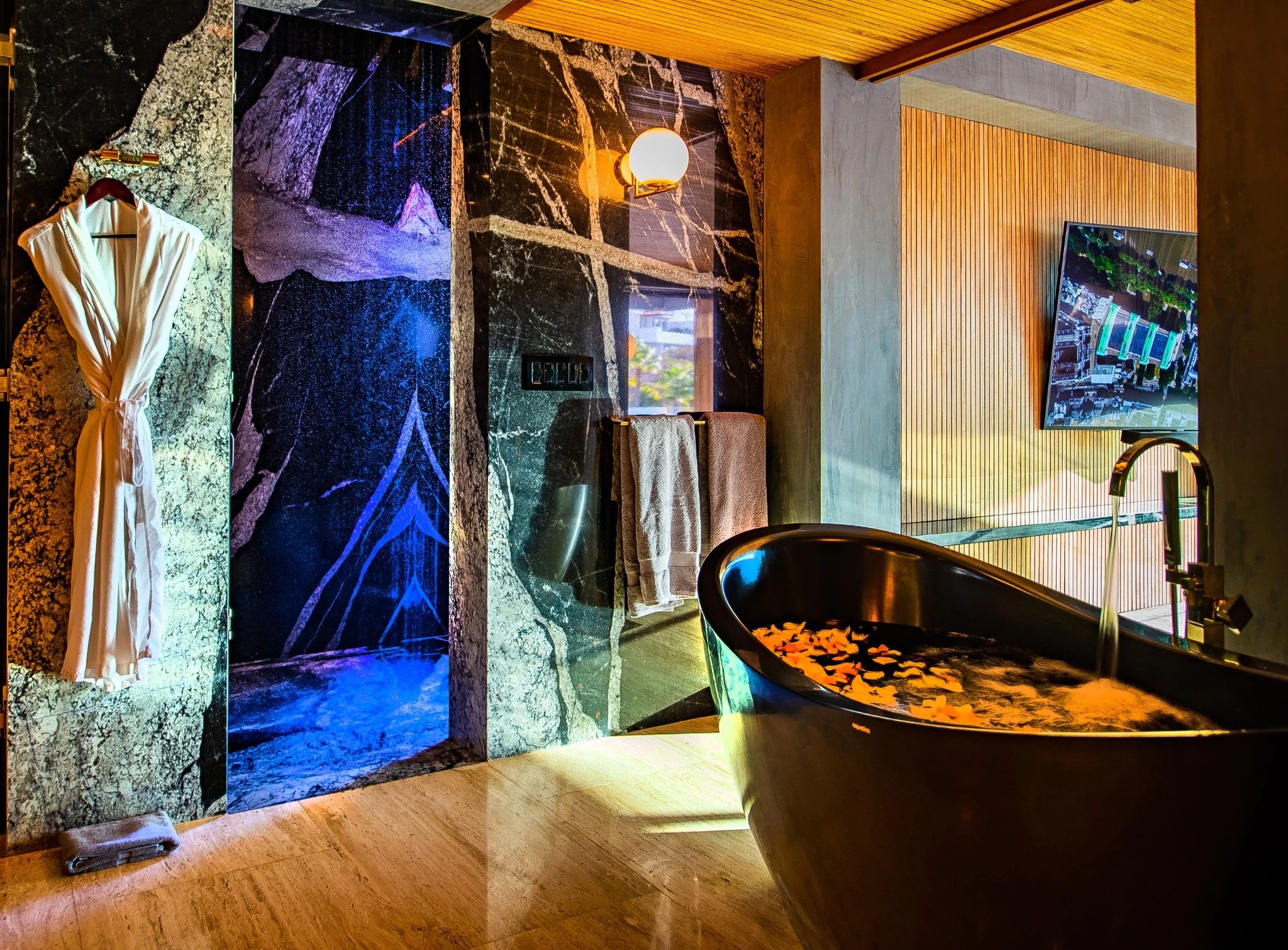 Sculptural bathtub and stone finishes