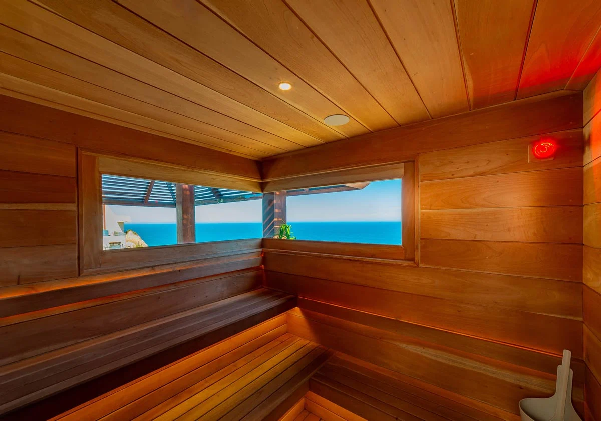 Wood-lined sauna with ocean-facing windows