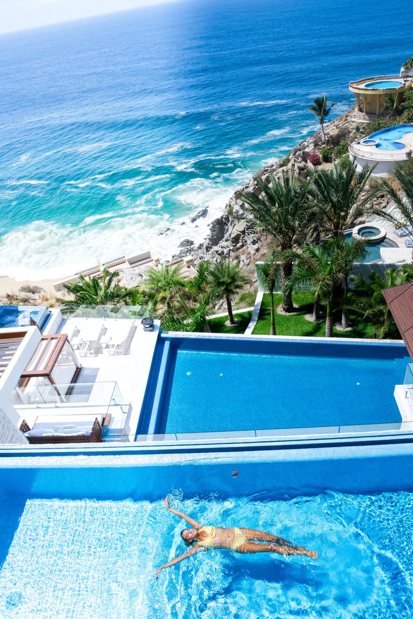 Pool, palms and Pacific shoreline