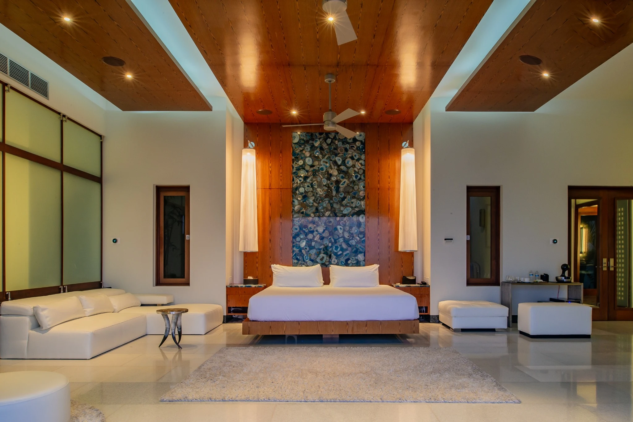 Bedroom with timber ceiling and stone feature wall